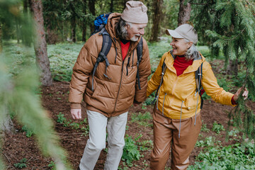 Mature woman and man walking together in forest