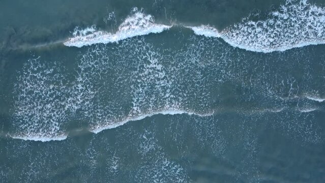 Top view of the Black Sea beach, shote in Mamaia, Romania. Aerial drone footage of sea waves reaching shore.
