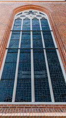 A large stained glass window in an old church