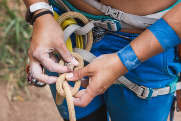Badass rock climber tying figure 8 knot