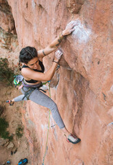 Focused woman jumping while rock climbing (dyno) - 3