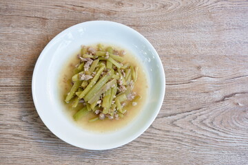 fried slice lotus stems with chop pork in soy sauce on plate