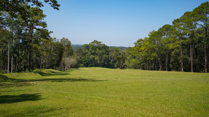 Beautiful golf course in a sunny day. Background evening golf course has sunlight shining down. Golf course in the countryside