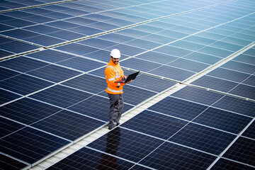 Renewable energy sources and solar engineer checking photovoltaic panels and electricity production.