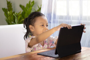 Asian girls watching online media at home are happy.