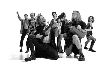 Group of emotive, expressive people, man and woman, rock music performers posing over white background. Black and white photography.