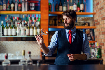 Barman checking the cleanliness of glass