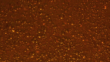 Carbon dioxide bubbles moving inside glass closeup. Fizzy cold alcohol beverage