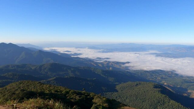 Tropical forest nature landscape view with mountain range and moving cloud mist at Kew Mae Pan nature trail, Doi Inthanon, Chiang Mai Thailand