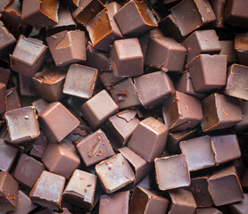 Background Fresh dark chocolate parts from the top view. close-up Chocolate chunk and cocoa background