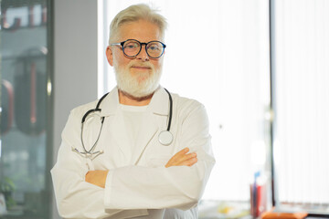 an elderly gray-haired male doctor in a medical office