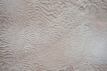 Background of natural white wall Pamukkale calcium travertine in Turkey, asymmetric pattern close-up. White cotton castle texture. Calcium stone textured