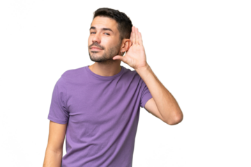 Young handsome caucasian man over isolated background listening to something by putting hand on the ear