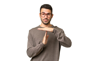Young handsome caucasian man over isolated background making time out gesture