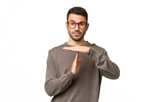 Young handsome caucasian man over isolated background making time out gesture