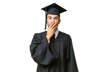 Young university graduate man over isolated background surprised and shocked while looking right