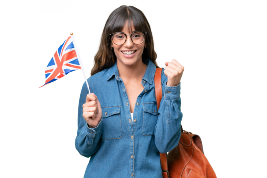 Young caucasian woman holding an United Kingdom flag over isolated background celebrating a victory in winner position