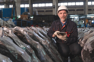 Engineer use tablet checking spares in factory spares train