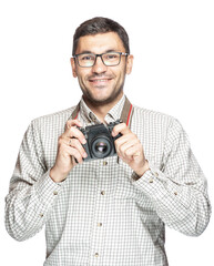 Handsome man in glasses and a plaid shirt, smiling and taking pictures with an vintage camera
