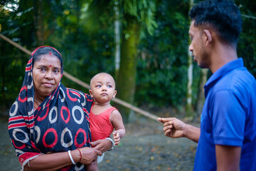 South asian hindu religious village kid with his grandmother and uncle 