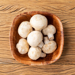 Paris mushrooms in a bowl over wooden table