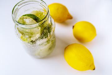 Pickled lemons and limes in sugar syrup