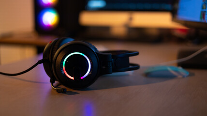 Plakat Closeup headset soft focus. Professional gamer playing video games on personal pc computer. Colorful neon light room. Esport online game.