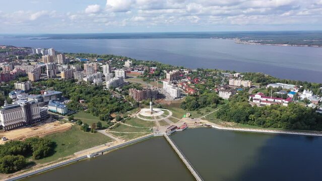 Scenic general aerial view of Cheboksary cityscape on banks of Volga River on sunny summer day, Chuvashia, Russia. High quality 4k footage