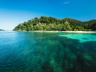 Scenic view of Koh Adang Island crystal clear turquoise sea with coral reef transparent water and summer blue sky. Near Koh Lipe Island, Tarutao National Marine Park, Satun, Thailand. Snorkeling Spot.