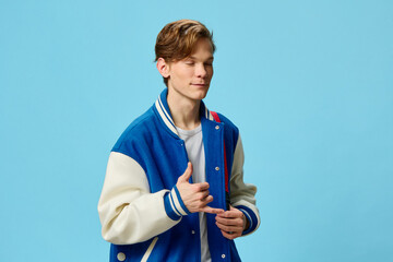 student in blue bomber jacket posing showing hand gestures