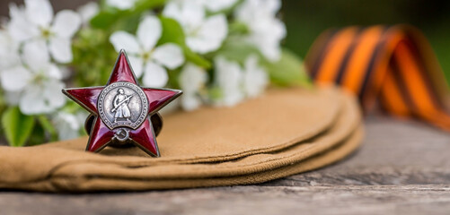 St. George's ribbon and the Order of the Red Star of the USSR World War II veteran on a wooden...