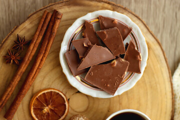 Cup of tea or coffee, various sweets and spices, Christmas decorations, comfy blanket, books and glasses. Top view.