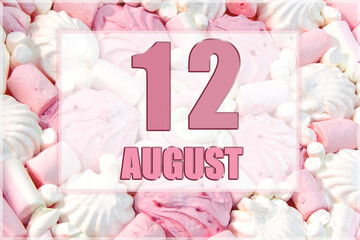 calendar date on the background of white and pink marshmallows. August 12 is the twelfth day of the month