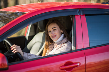 happy brunette girl travels in autumn in a red car, the concept of travel and autumn holidays, vacation