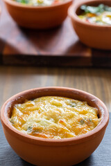 vegetables with quail eggs cooked in the single-portion earthenware bowl
