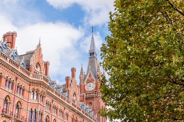 Naklejka premium Exterior view of St Pancras Railway Station. This building now houses the luxury St Pancras Renaissance Hotel, London, England, UK, October 15, 2022