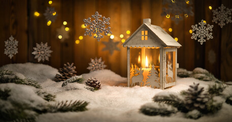 Christmas scene with lantern and hanging ornaments, wood background and snow, the burning candle...