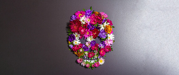 Paper human skull for Mexico's Day of the Dead (El Dia de Muertos) with traditional flowers