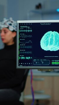 Vertical video: Neurologist doctor analysing nervous system using eeg headset scanning woman brain. Scientist researcher using high tech developing neurological innovation, monitoring side effects on