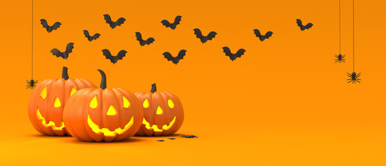 Halloween decoration with pumpkins, bats, and spiders, on orange background with copy space. Jack O’ Lantern pumpkins. Happy halloween holiday concept