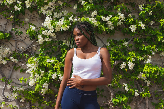 Young calm black woman in summer garden