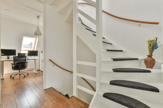 Staircase located in light corridor leading to study room