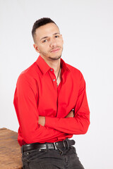 Man in red shirt looking thoughtful