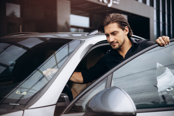 Fototapeta na wymiar Handsome man standing by his new car