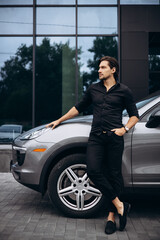 Fototapeta na wymiar Handsome man standing by his new car