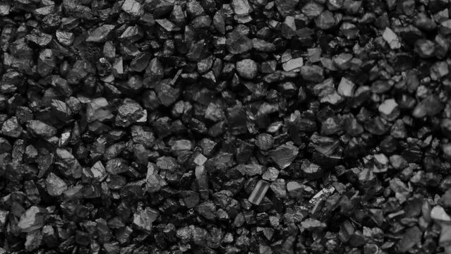 Black sand moving. Close-up of a black sand surface moving.