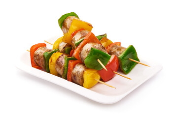 Kebab - grilled pork sausage skewers and vegetables BBQ, close-up, isolated on white background.