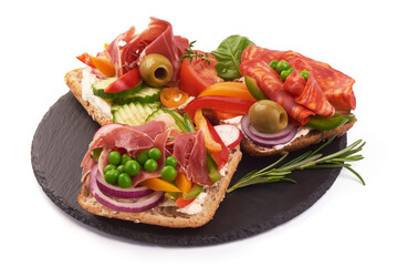 Sandwiches with jamon vegetables and lettuce on white background