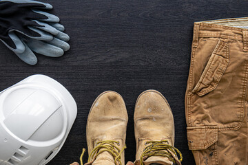 Builder clothes, worker uniform on wooden background, flat lay.