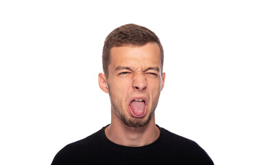 Fototapeta premium A young man and makes a disgusted grimace on a white background.